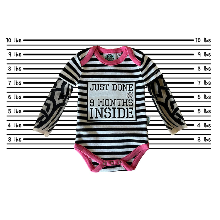 Stripy Just Done 9 Months Inside vest with tattoo sleeves against a police line-up background