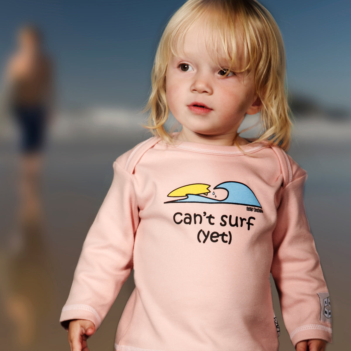 picture of girl on beach wearing can't surf yet pink t shirt