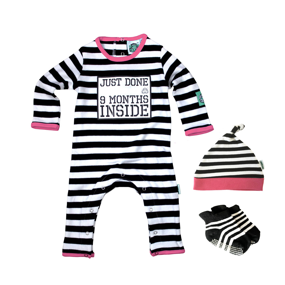 Black and white baby grow with pink trim featuring slogan Just Done 9 Months Inside, matching hat and baby socks