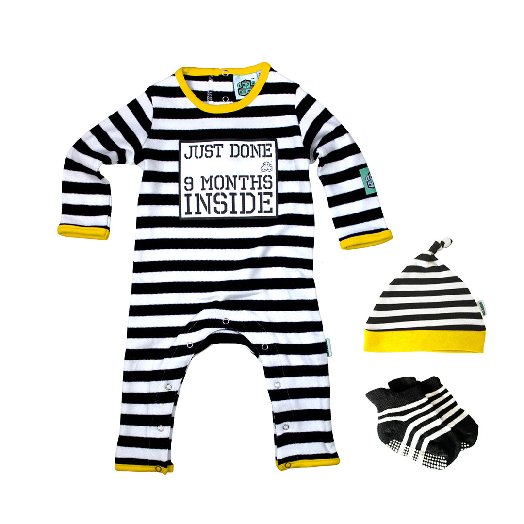 Black and white stripy baby grow with yellow trim with printed slogan Just Done 9 Months Inside, matching baby hat and socks