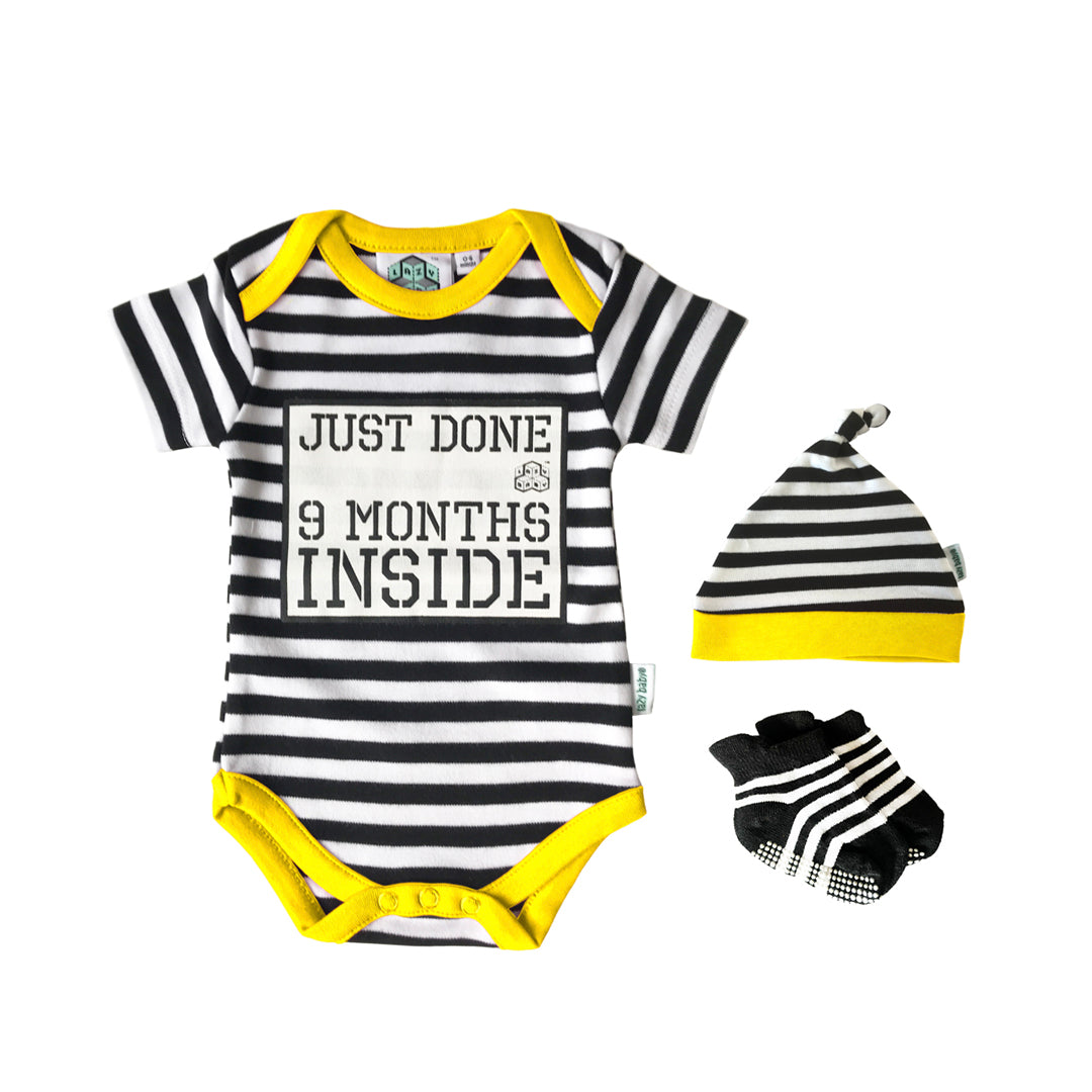 Just Done 9 Months Inside slogan vest in black and white stripes with yellow edging trim and matching stripy hat and socks