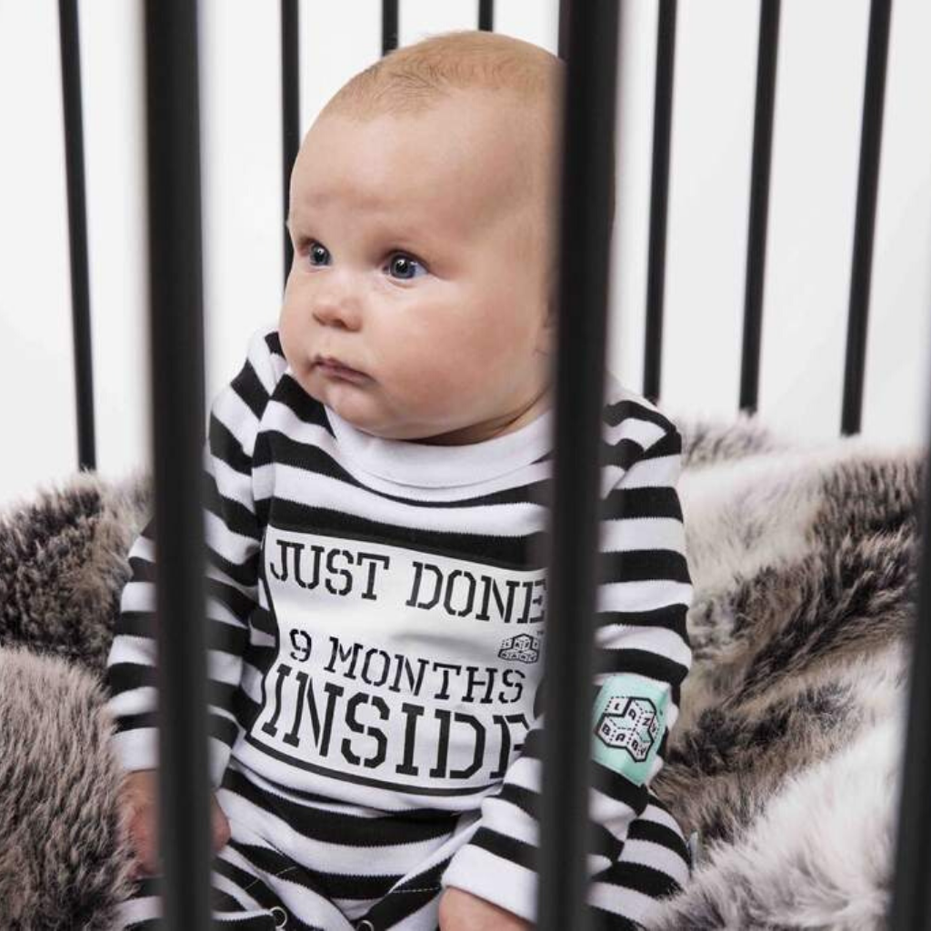 Baby Wearing Just Done 9 Months Inside Baby Grow Sitting in Cot Jail